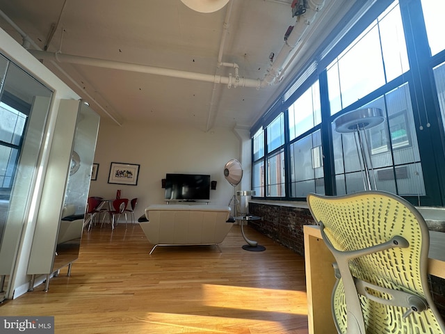 living room featuring a towering ceiling and light wood-type flooring