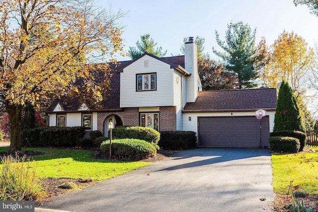 view of front facade with a garage and a front lawn