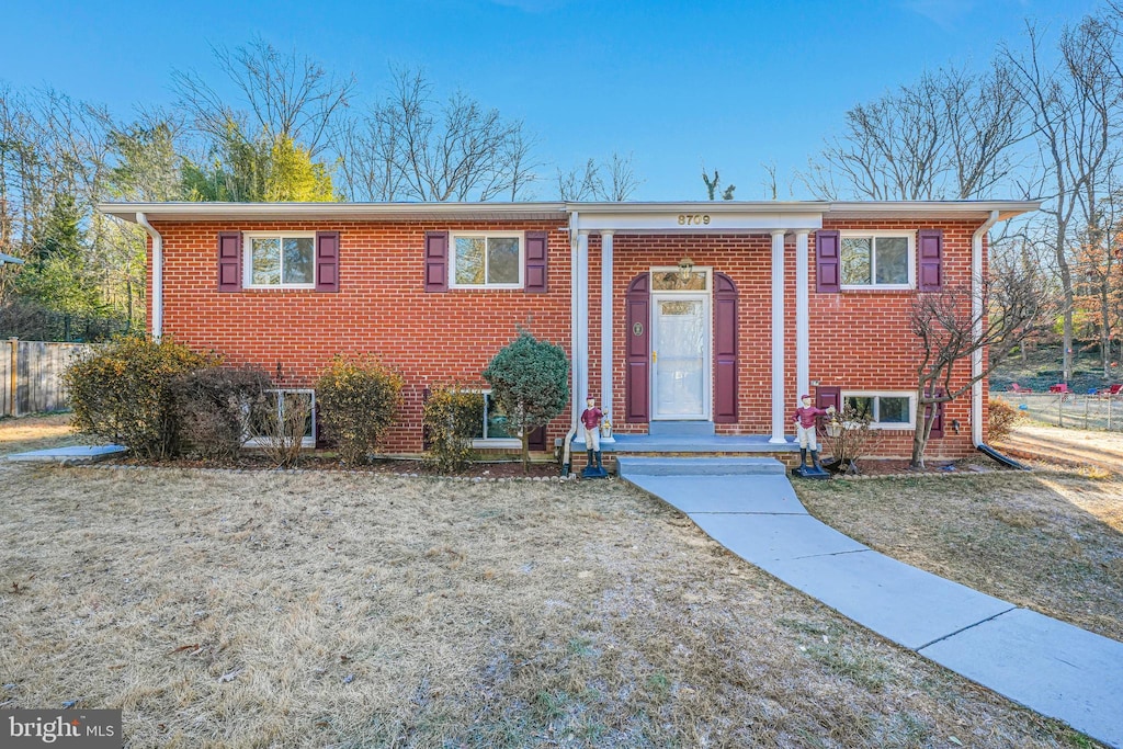 raised ranch with a front yard