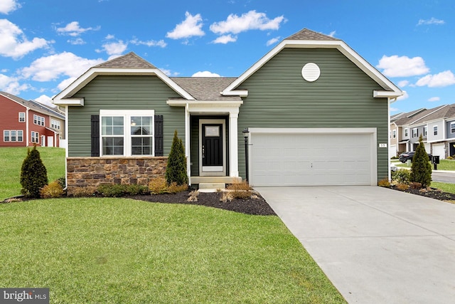 view of front of house featuring a front yard and a garage