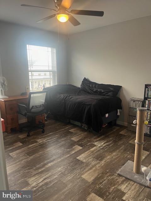 bedroom with dark hardwood / wood-style floors and ceiling fan