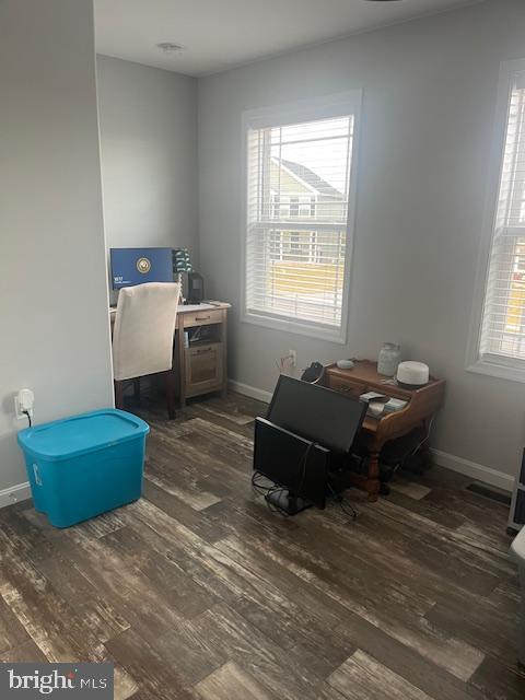 office area featuring plenty of natural light and dark hardwood / wood-style flooring