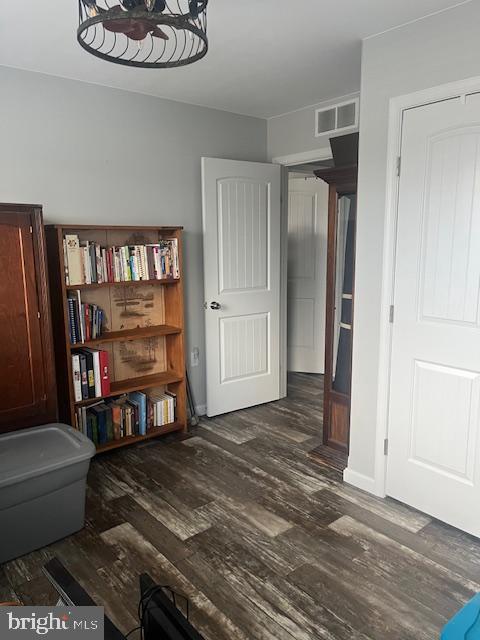 interior space with dark hardwood / wood-style floors and a notable chandelier