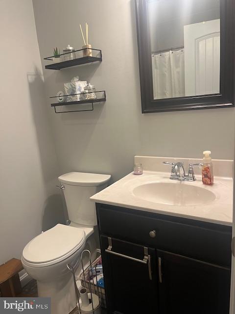 bathroom featuring vanity and toilet