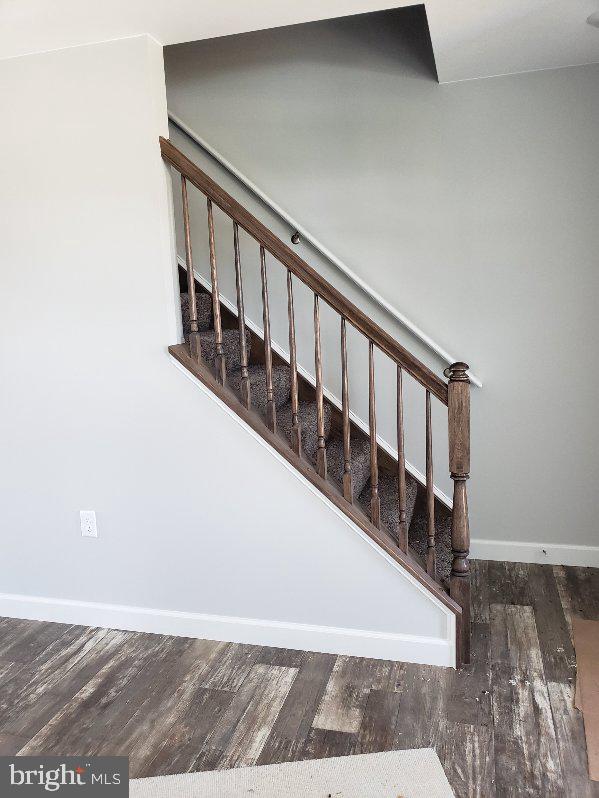 staircase with hardwood / wood-style floors