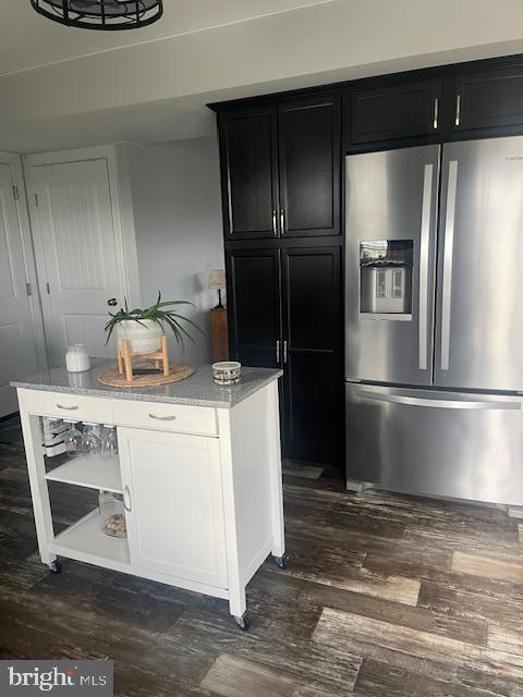 kitchen featuring stainless steel fridge with ice dispenser, white cabinets, light stone countertops, and dark hardwood / wood-style floors