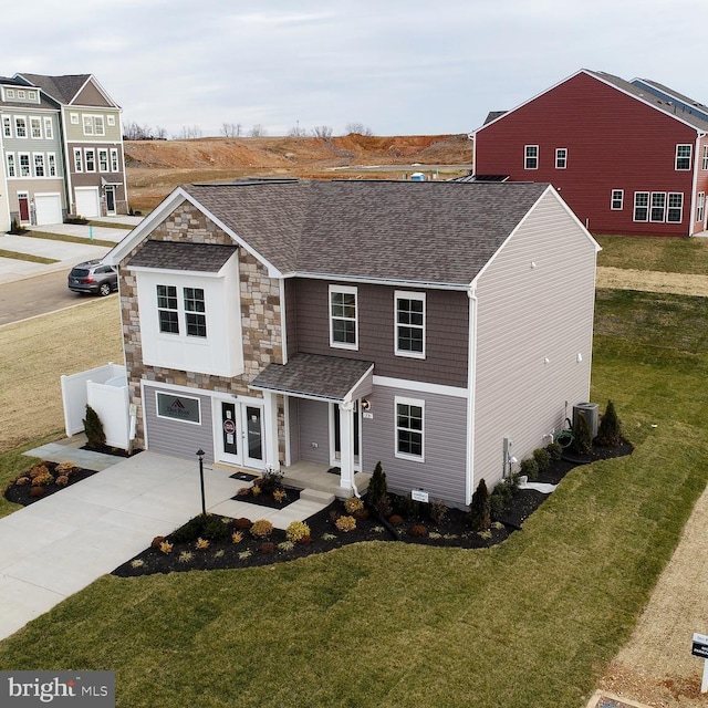 front facade with a garage, central AC unit, and a front yard