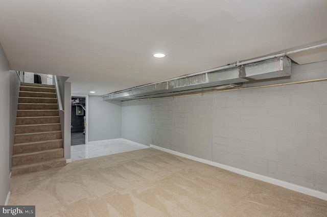 basement featuring light carpet