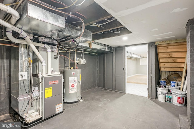 basement featuring heating unit and water heater