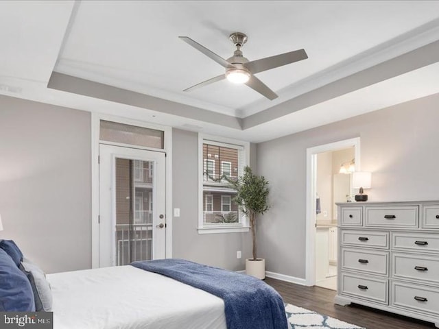 bedroom featuring access to outside, a raised ceiling, ceiling fan, connected bathroom, and dark hardwood / wood-style floors