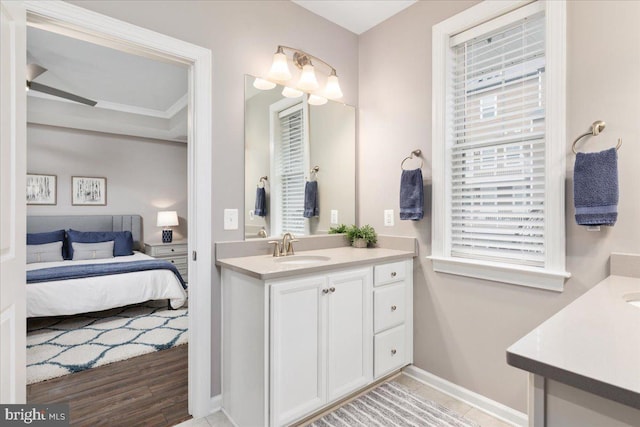 bathroom with hardwood / wood-style floors, vanity, and crown molding