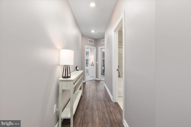 corridor featuring dark hardwood / wood-style floors