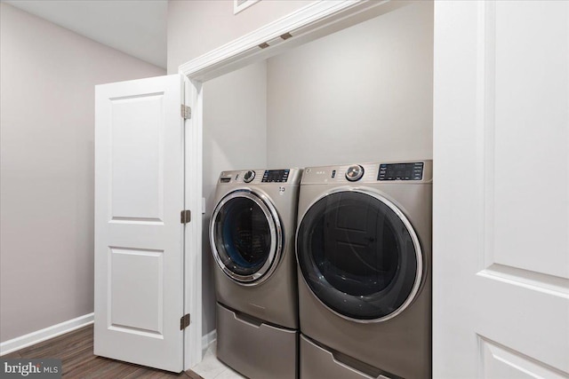 laundry room with hardwood / wood-style flooring and independent washer and dryer