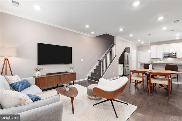 living room with hardwood / wood-style floors and crown molding