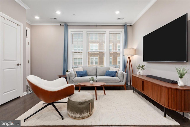 living room with hardwood / wood-style flooring and crown molding