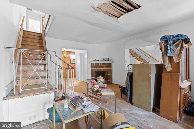 living room with a notable chandelier and a brick fireplace