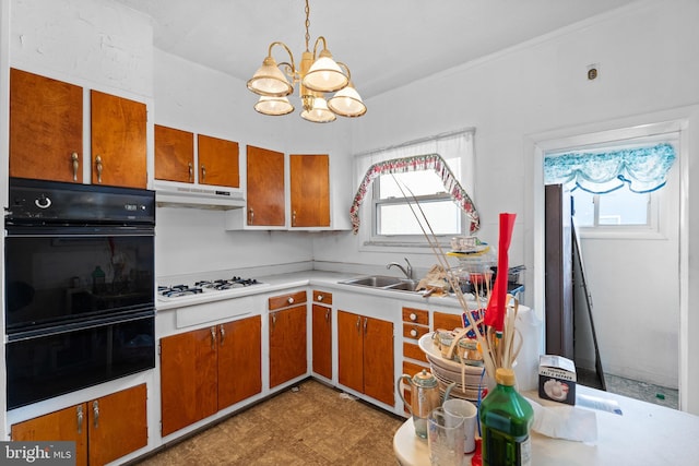 kitchen featuring black double oven, white gas cooktop, sink, a notable chandelier, and hanging light fixtures