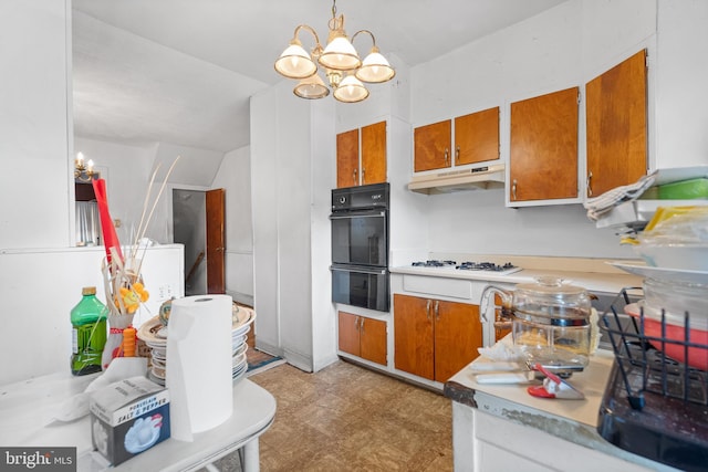 kitchen with white gas stovetop, black double oven, decorative light fixtures, and a notable chandelier