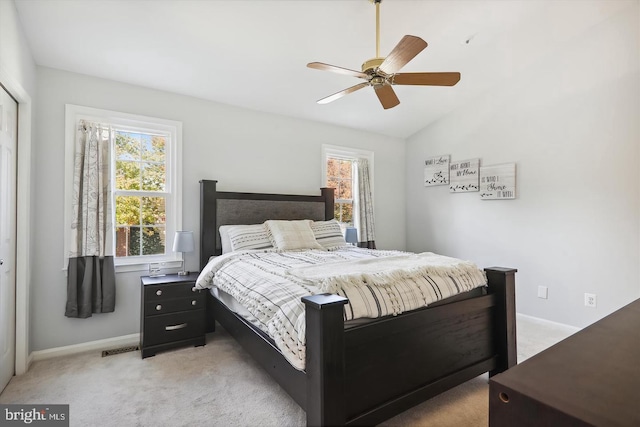 bedroom featuring ceiling fan, lofted ceiling, and light carpet