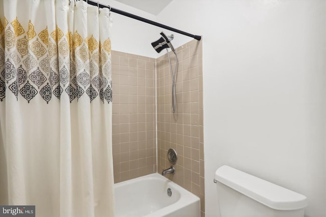 bathroom featuring shower / bath combination with curtain and toilet