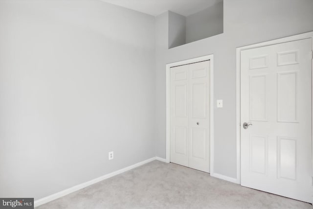 unfurnished bedroom featuring light carpet