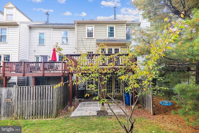 rear view of property with central AC and a deck