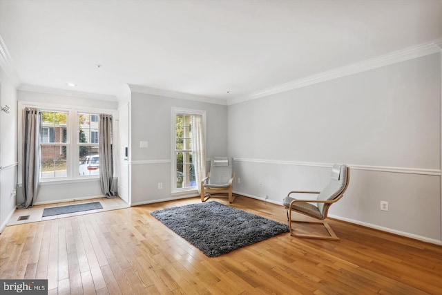 unfurnished room featuring light hardwood / wood-style floors and ornamental molding