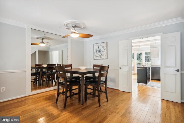 dining room featuring ceiling fan, ornamental molding, and light wood-type flooring