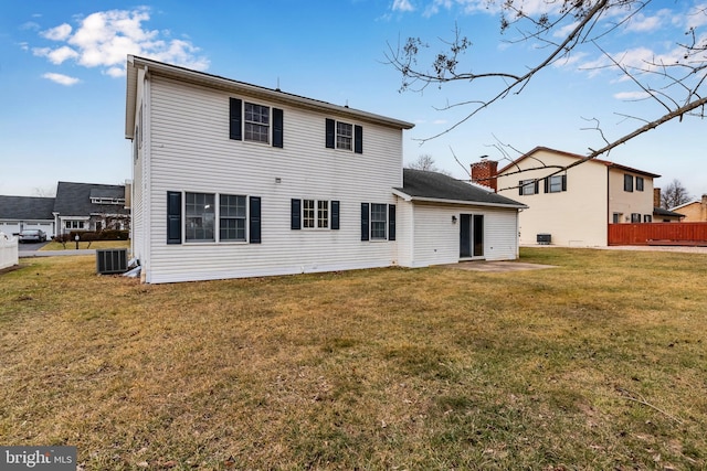 back of house featuring a yard and central AC