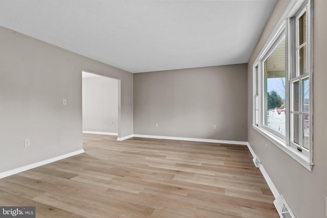 spare room featuring light hardwood / wood-style floors