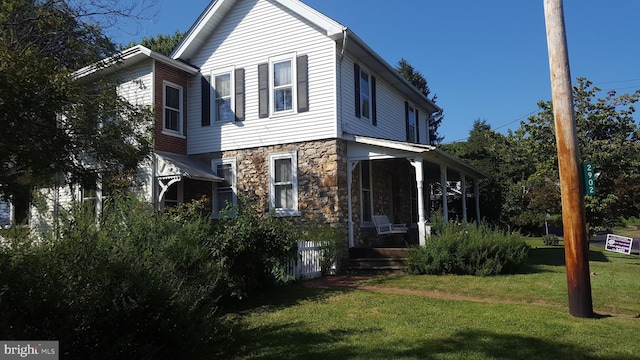 view of side of property with a yard