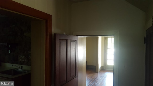 hallway with light hardwood / wood-style flooring and sink