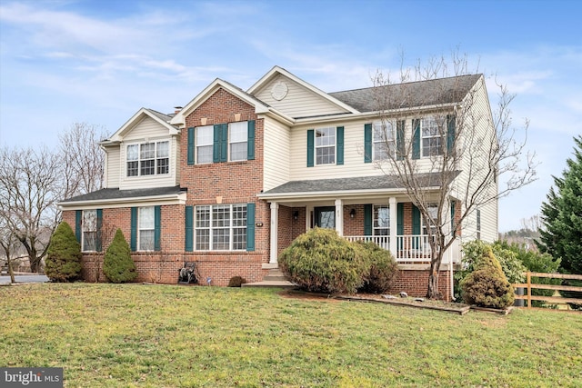 view of front of property with a porch and a front lawn