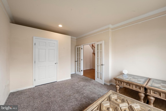 unfurnished bedroom featuring carpet flooring, crown molding, and french doors