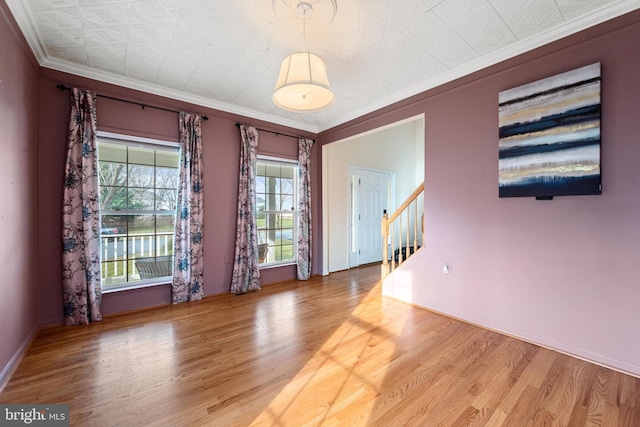 interior space featuring hardwood / wood-style floors and ornamental molding