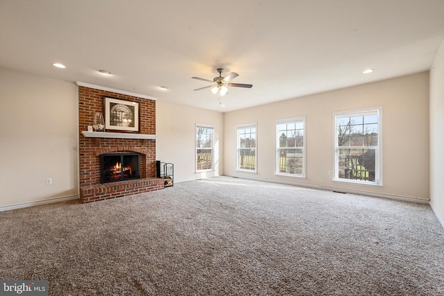 unfurnished living room featuring ceiling fan, carpet floors, and a fireplace