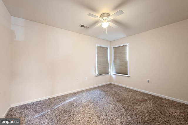 carpeted empty room featuring ceiling fan