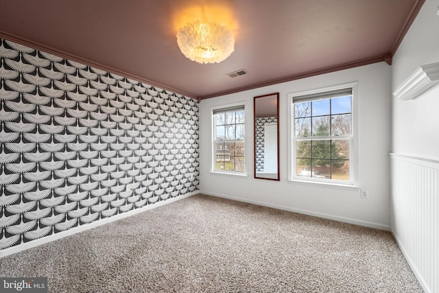 carpeted spare room featuring ornamental molding