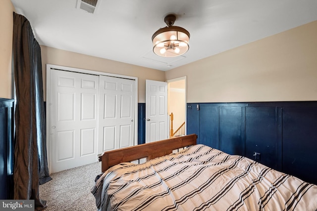 carpeted bedroom featuring a chandelier and a closet