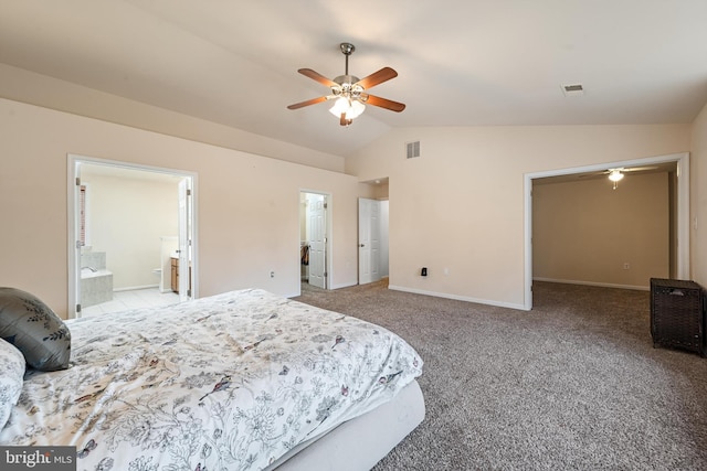 carpeted bedroom with ensuite bath, ceiling fan, lofted ceiling, and a walk in closet