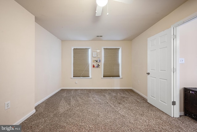 spare room with carpet flooring and ceiling fan