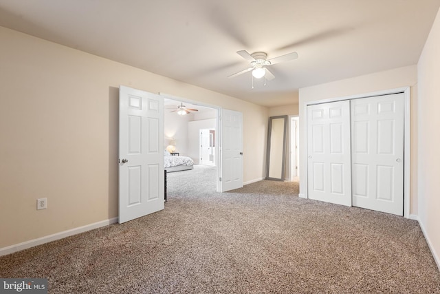 unfurnished bedroom with ceiling fan, a closet, and carpet floors