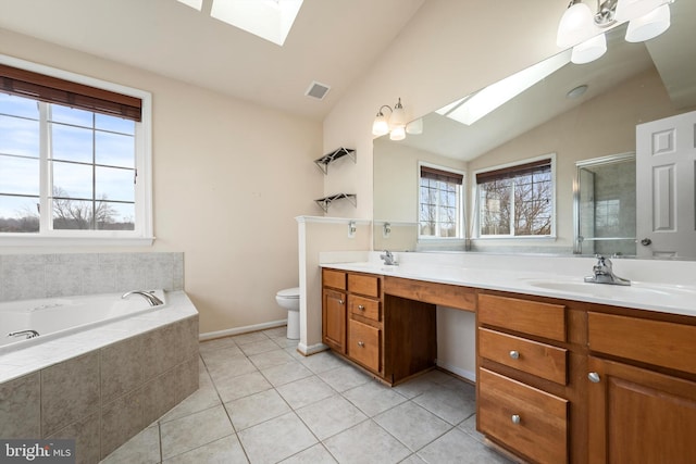 full bathroom featuring tile patterned floors, lofted ceiling with skylight, a healthy amount of sunlight, and toilet