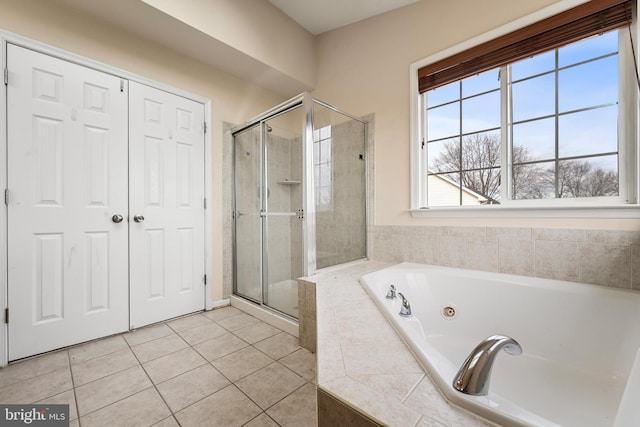 bathroom featuring tile patterned floors and independent shower and bath