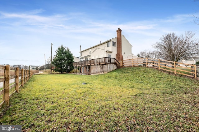 view of yard with a rural view and a deck