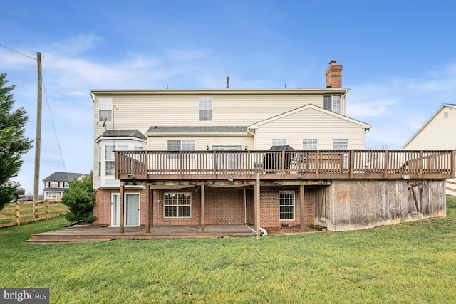 back of house featuring a wooden deck and a yard