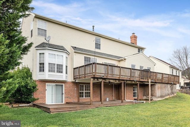 rear view of property with a lawn and a wooden deck