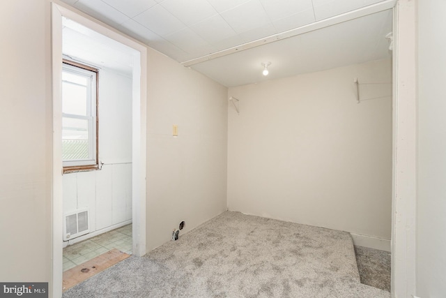 unfurnished room with visible vents and carpet flooring