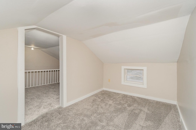 bonus room with lofted ceiling, baseboards, and carpet floors