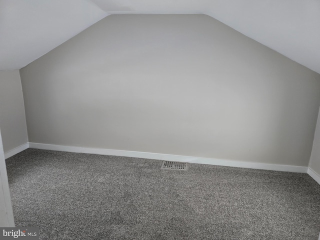 bonus room featuring visible vents, baseboards, carpet, and lofted ceiling